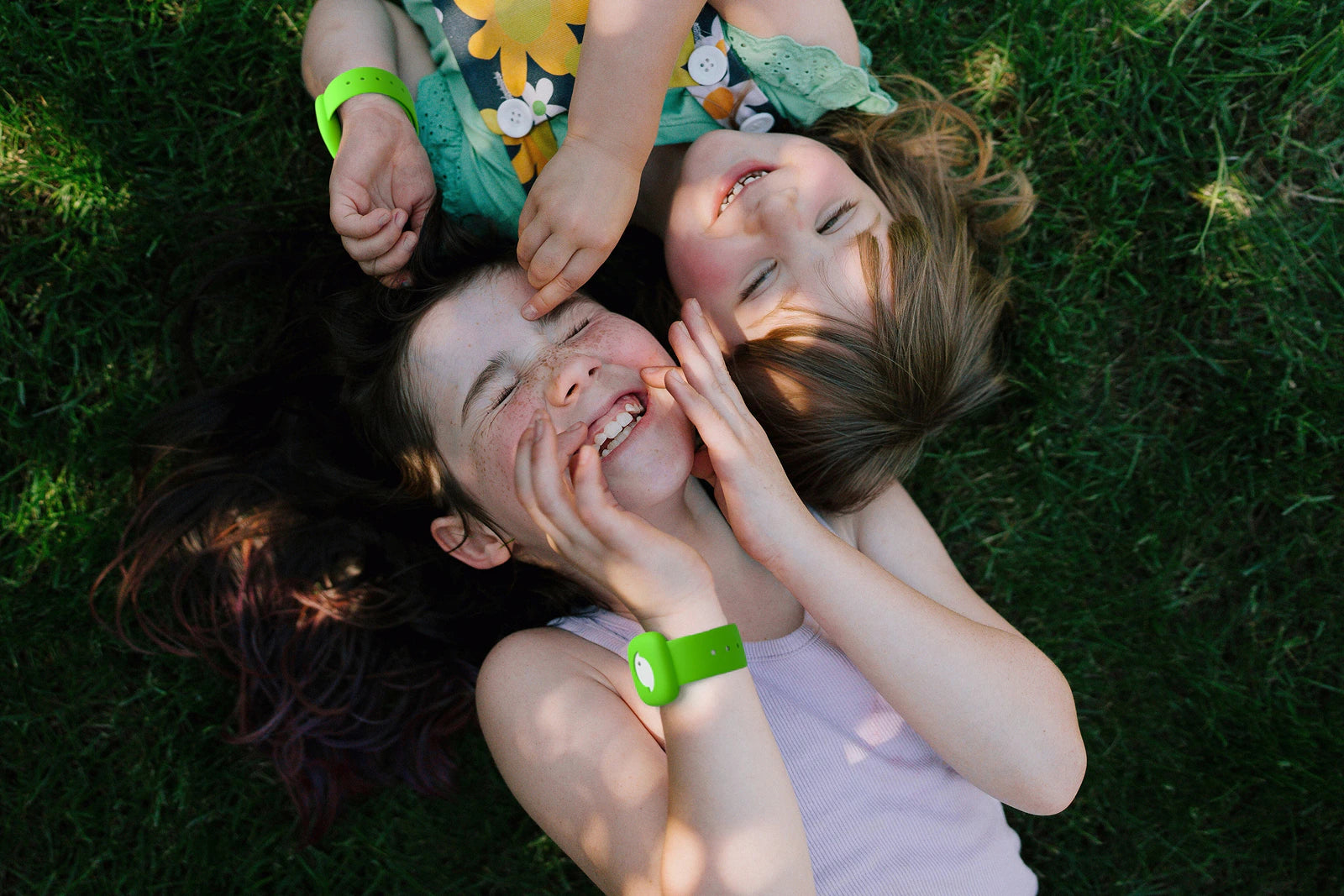 Girls wearing littlebird tracker in grass